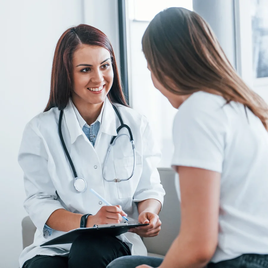 Physician speaking with a woman during a bacterial vaginosis clinical trial screening appointment at Equity Medical, serving research participants nationwide.