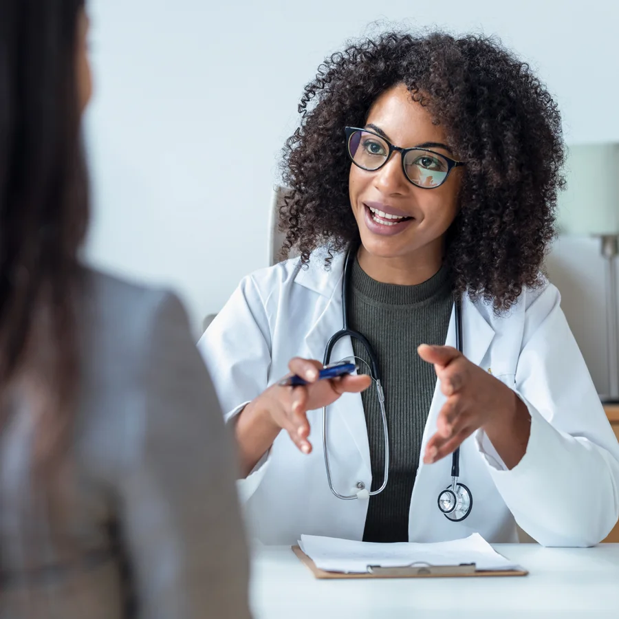 Physician speaking with a woman about menopause research participation and potential clinical trial eligibility at Equity Medical.